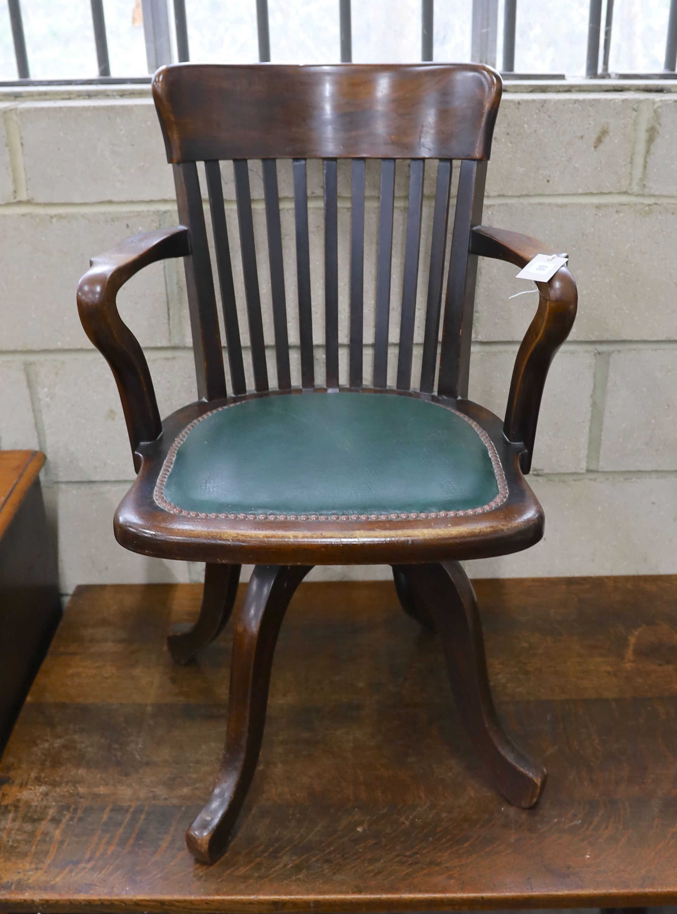 A 20th century beech swivel desk chair